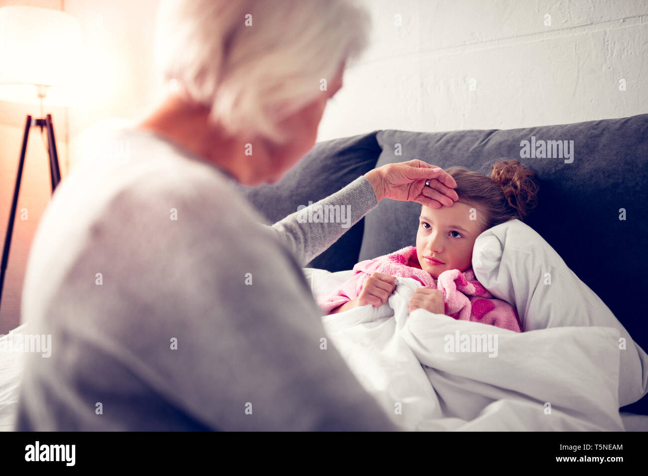 Granddaughter feeling sick after eating too much ice cream Stock Photo