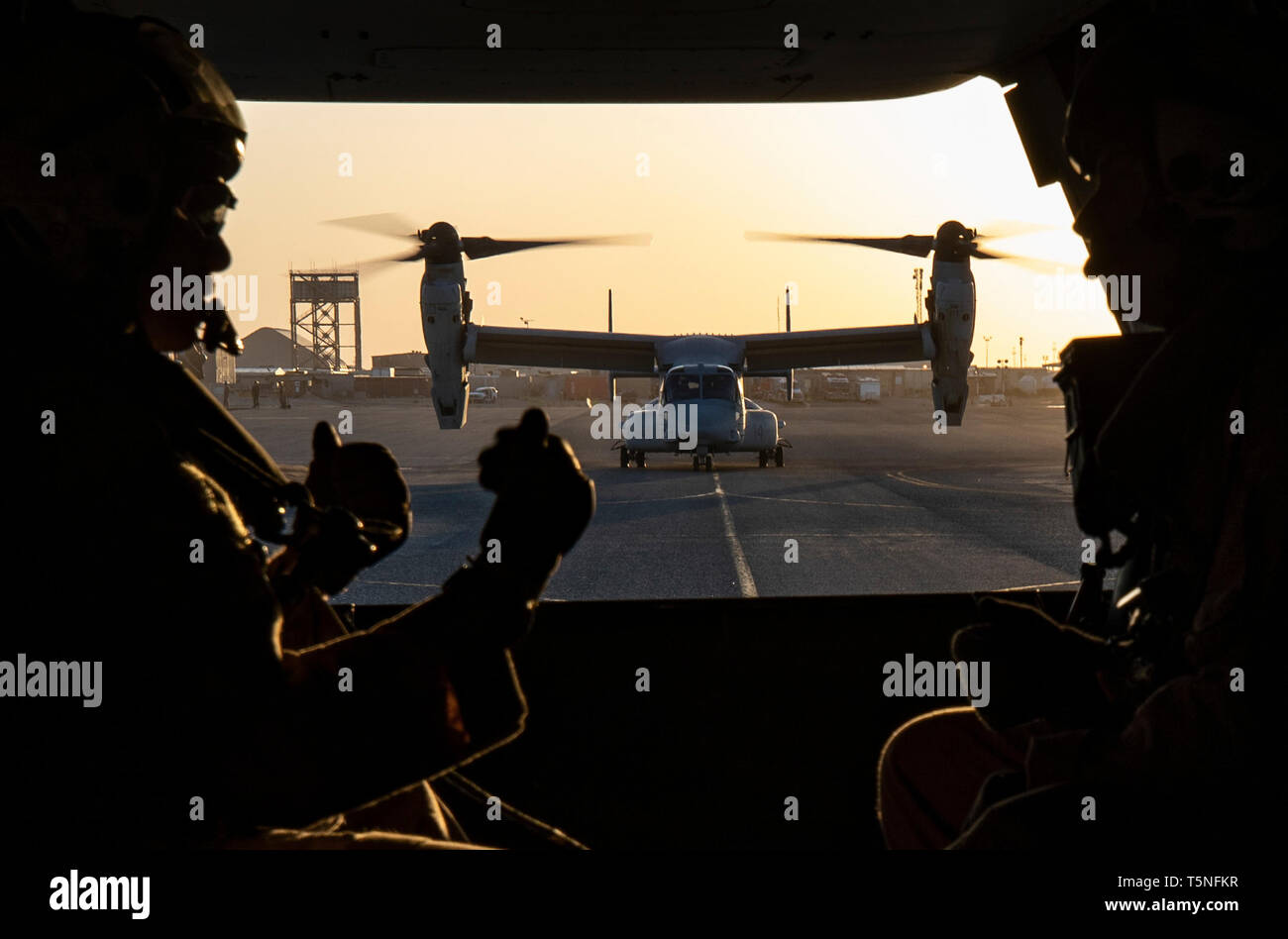 A U.S. Marine MV-22 Osprey with the 22nd Marine Expeditionary Unit taxis down the flight line prior to taking off and beginning a tail gun shoot during a MEU exercise. The training allowed Marines with Marine Medium Tiltrotor Squadron 264 (Reinforced) to familiarize themselves with operating the weapon during flight and maintain combat readiness. Marines and Sailors with the 22nd MEU and Kearsarge Amphibious Ready Group are currently deployed to the U.S. 5th Fleet area of operations in support of naval operations to ensure maritime stability and security in the Central region, connecting the M Stock Photo