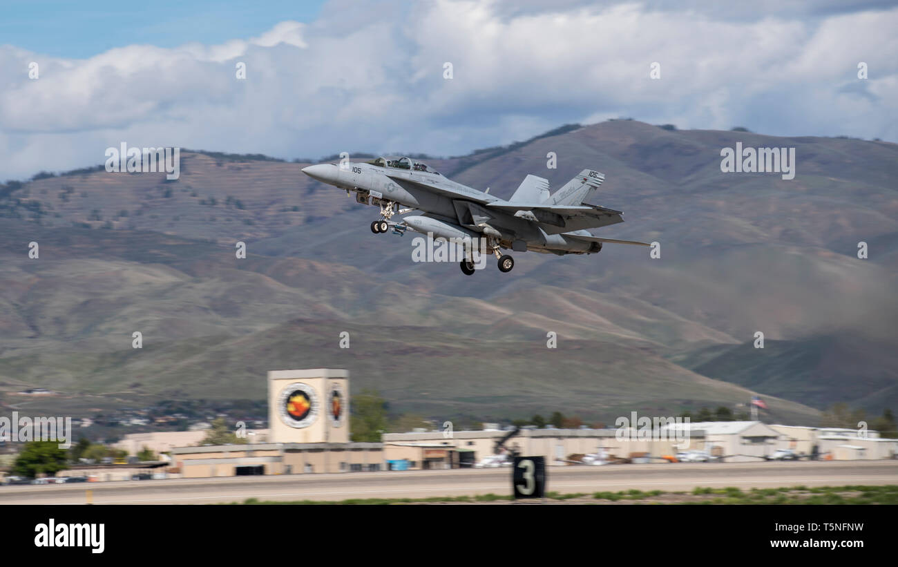 An F/A-18F Super Hornet assigned to the U.S. Navy’s Strike Fighter Squadron 32 based ashore at Naval Air Station Oceana, Virginia Beach, Virginia takes off from Gowen Field, Boise, Idaho on April 23, 2019. The aircraft is in Idaho to train with A-10 Thunderbolt IIs from the 190th Fighter Squadron. (U.S. Air National Guard photo by Master Sgt. Joshua C. Allmaras) Stock Photo