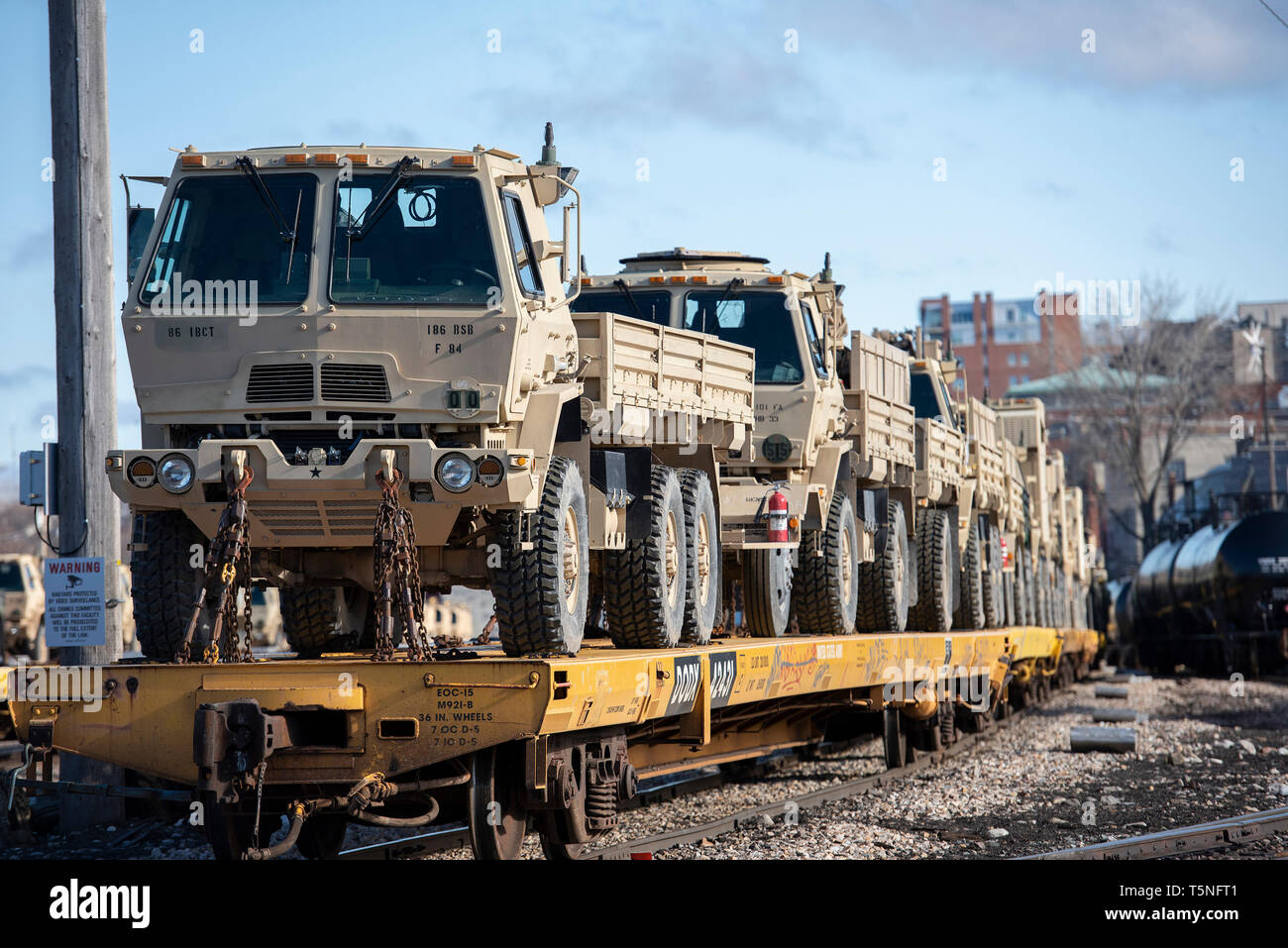 U.S. Army tactical vehicles assigned to the 86th Infantry Brigade Combat Team (Mountain), awaits transport after being loaded onto rail cars in Burlington, Vt., April 16, 2019. Soldiers from Vermont, Massachusetts and Connecticut loaded and over 600 vehicles onto 210 rail cars to be transported to Fort Polk, Louisiana in preparation for a Joint Readiness Training Center rotation next month. (U.S. Air National Guard photo by Master Sgt. Sarah Mattison) Stock Photo