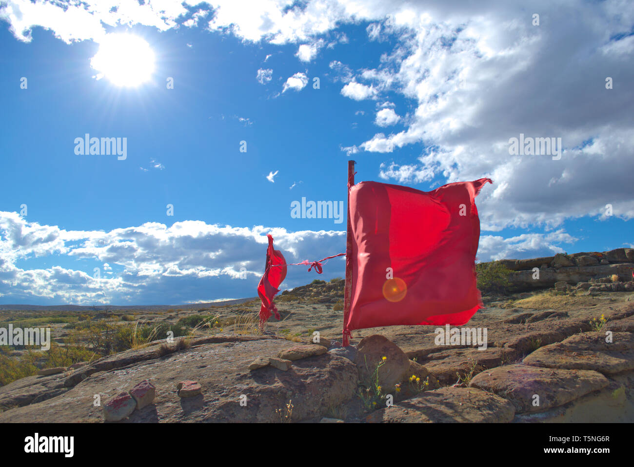 Red waving flags at a sactuary to the Gauchito Gil, a local saint and folk hero, in Neuquen, Argentinian Patagonia. Stock Photo