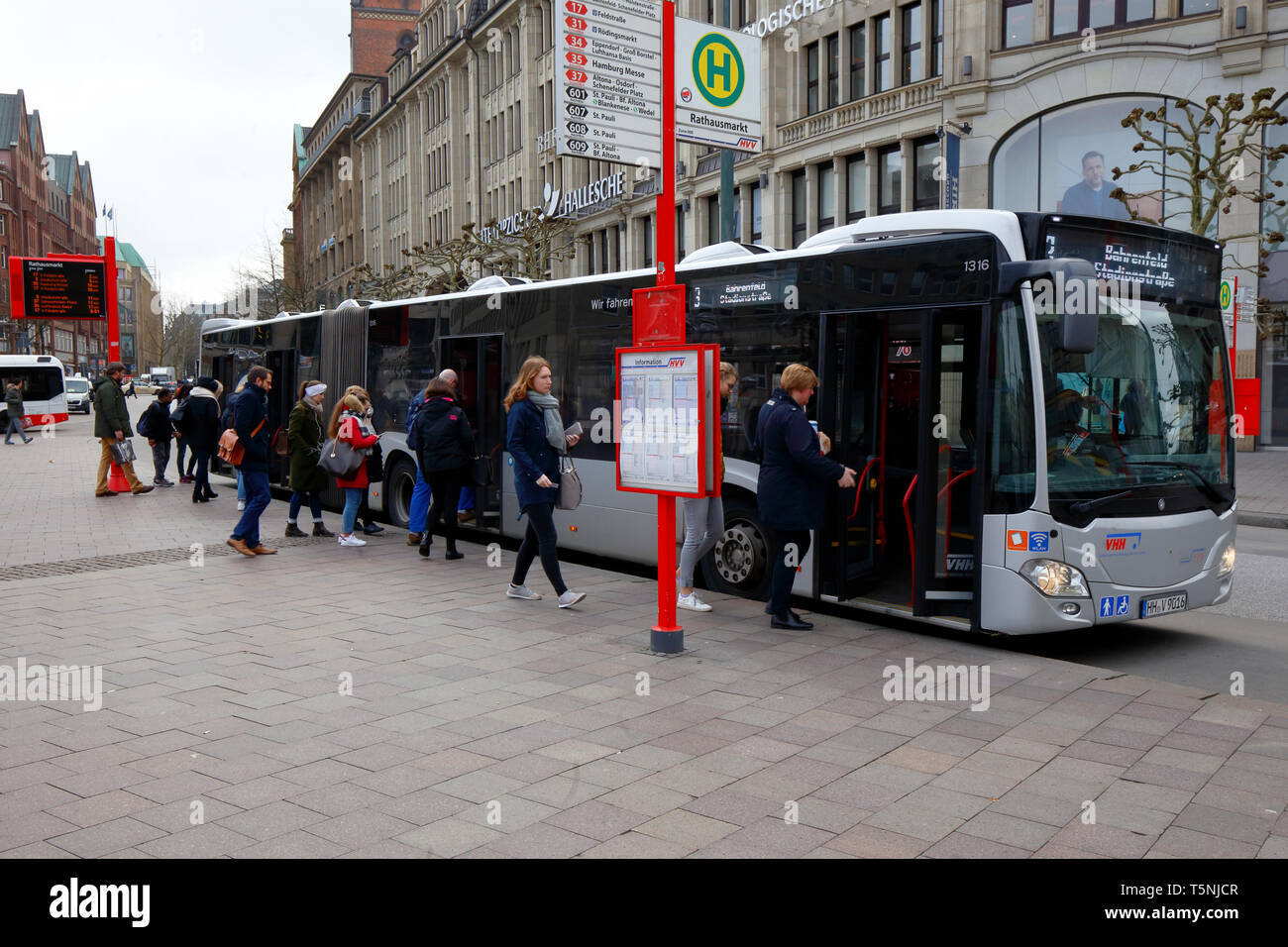 People queuing for a bus outside Rathausmarkt in Hamburg, Germany Stock Photo