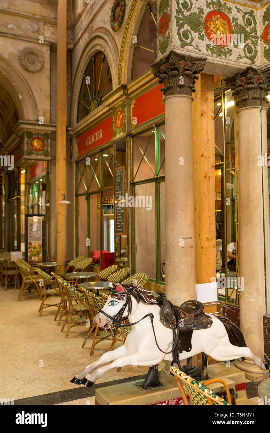 Carousel or merry-go-round horse in a café in Bordeaux, Gironde. / Cheval de manège dans un café de Bordeaux à l'entrée de la galerie Bordelaise. Stock Photo