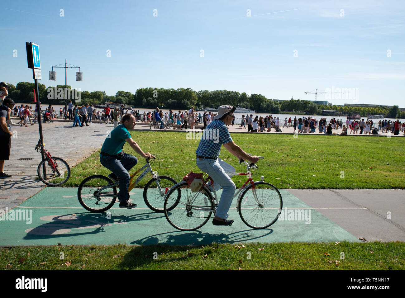 Cyclists in Bordeaux along the Garonne river, Gironde, France. Stock Photo
