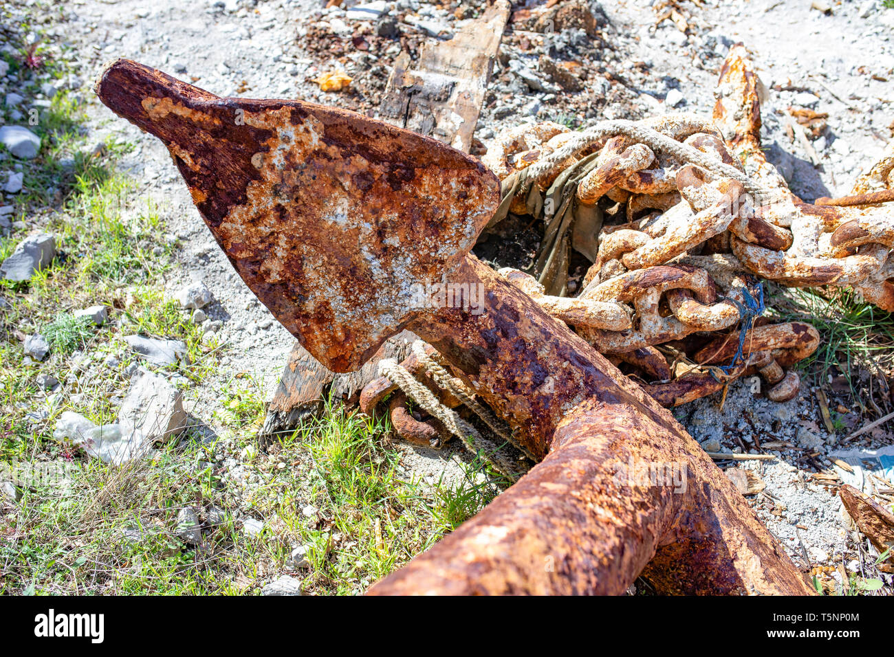 Rusty anchors and the anchor chain links in a harbor. Greece Stock