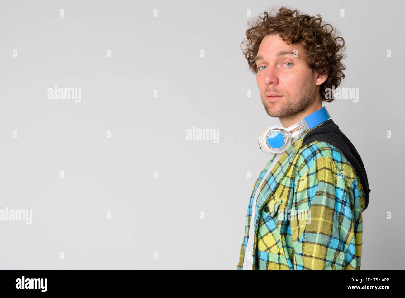 Profile View Of Handsome Hipster Man With Curly Hair Looking At
