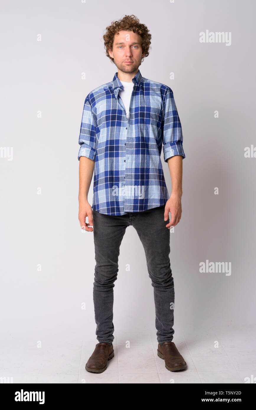 Full Body Shot Of Handsome Hipster Man With Curly Hair Stock Photo