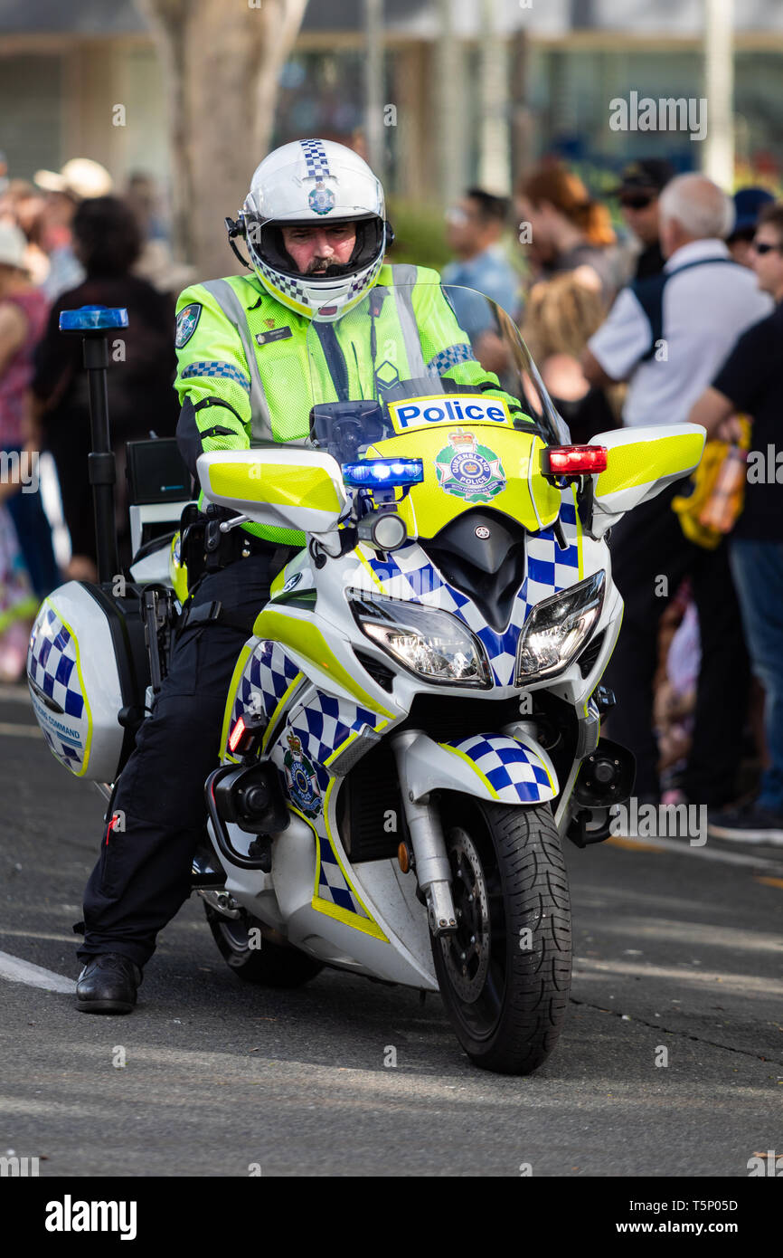 A motorcycle police officer clearing the street for the march procession to pass by. Dressed in full uniform on a police motorcycle Stock Photo