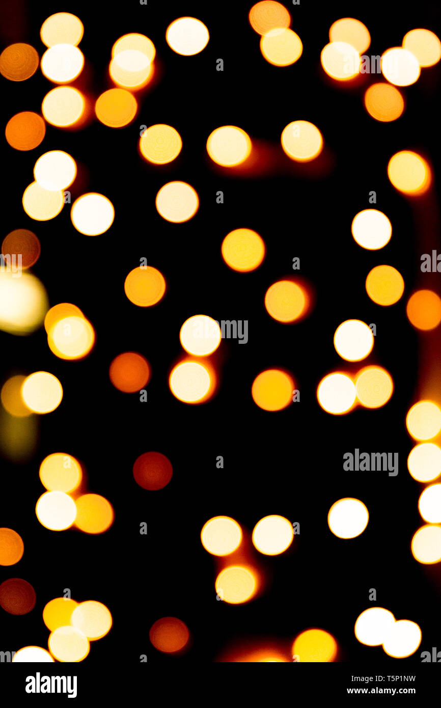 Unfocused abstract gold bokeh on black background. defocused and blurred  many round light Stock Photo - Alamy