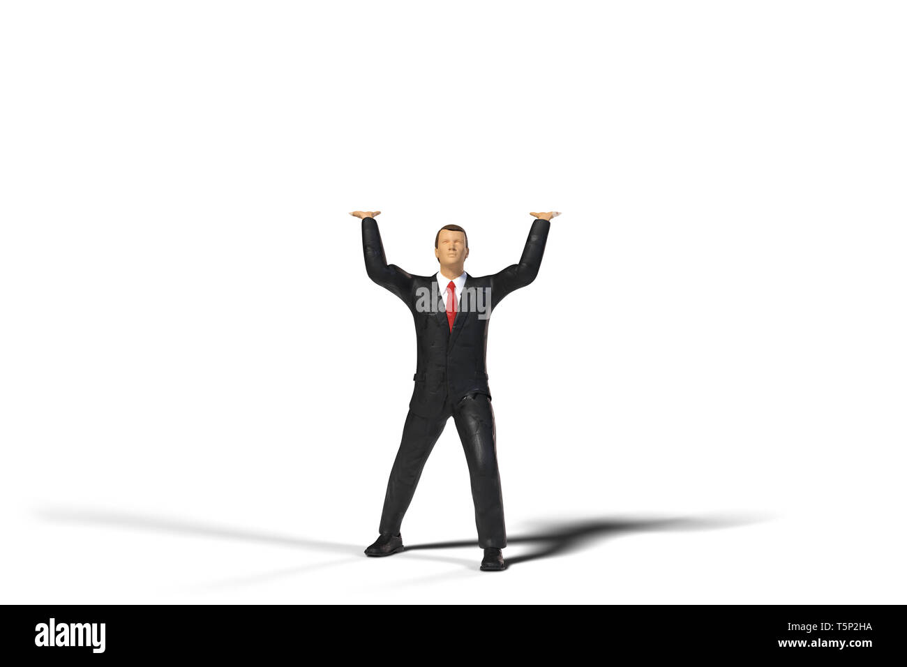 toy miniature businessman figure lifting an empty space, concept isolated on white background Stock Photo