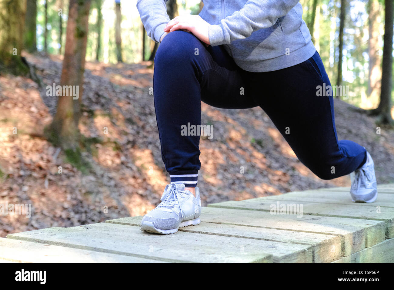 Sports injury. Woman with pain in knee while jogging Stock Photo