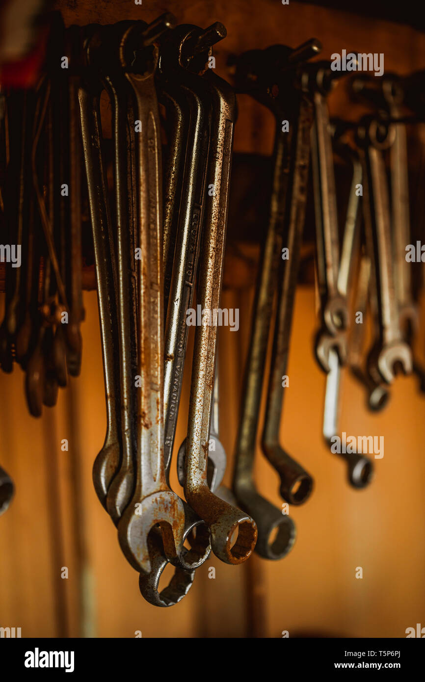 different organized metal spanner tools in a garage, close up Stock