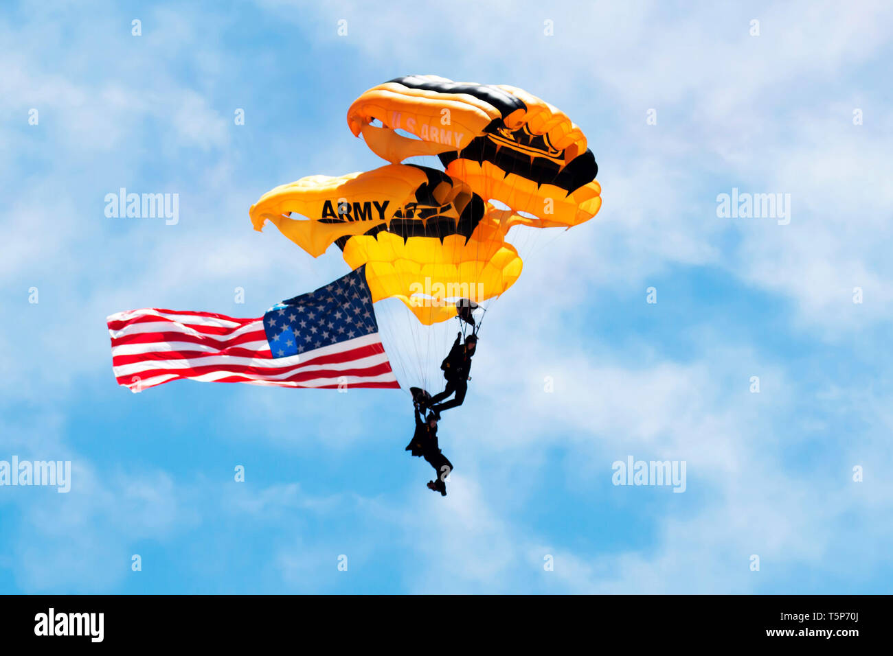 Wantagh, NY, United States - 26 May 2017: US Army paratroopers carrying the american flag open up the practice show for the air show. Stock Photo