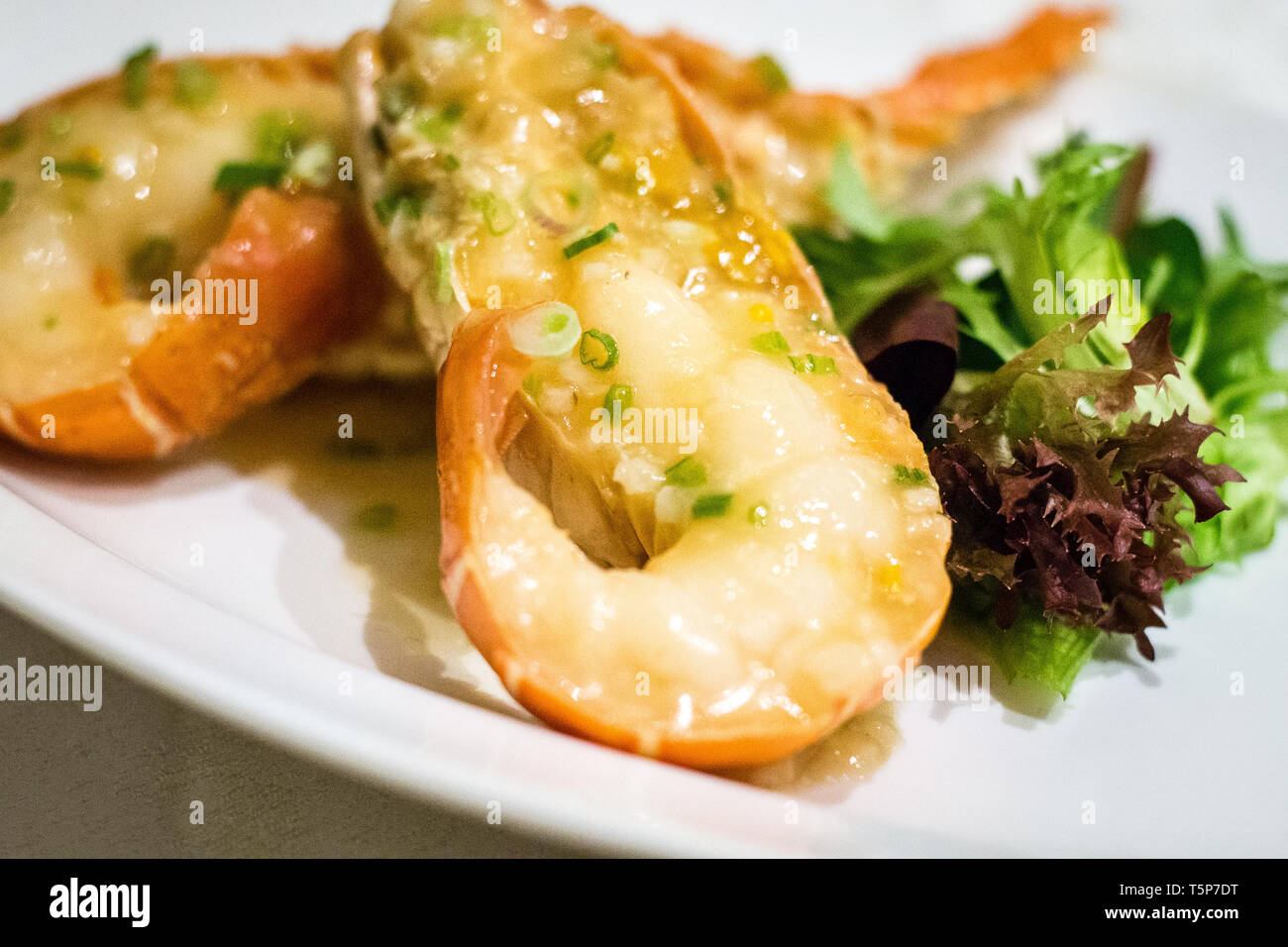 Stir fry Australian lobster with savoury sauce and spring onions and