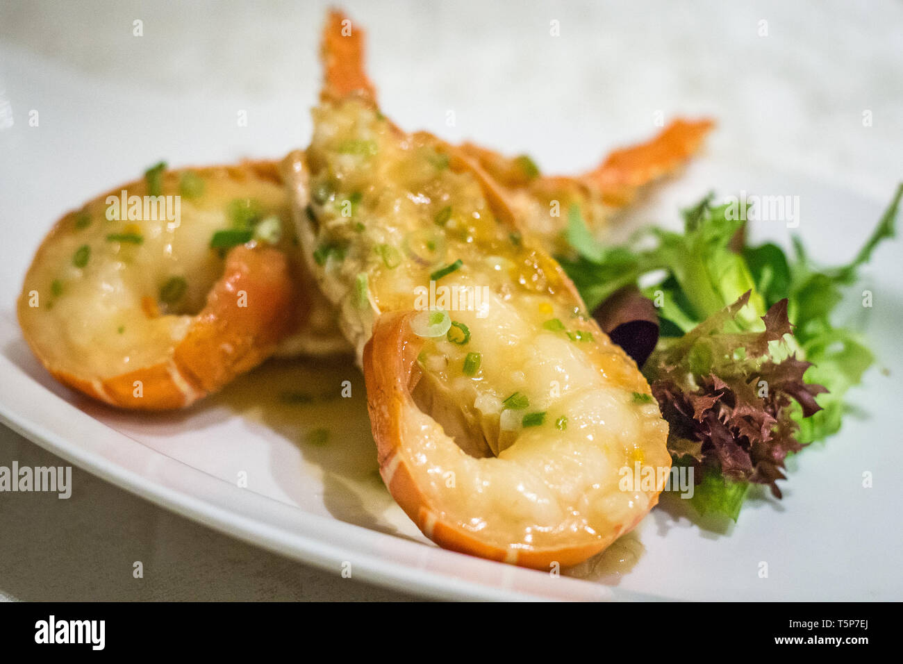 Stir fry Australian lobster with savoury sauce and spring onions and