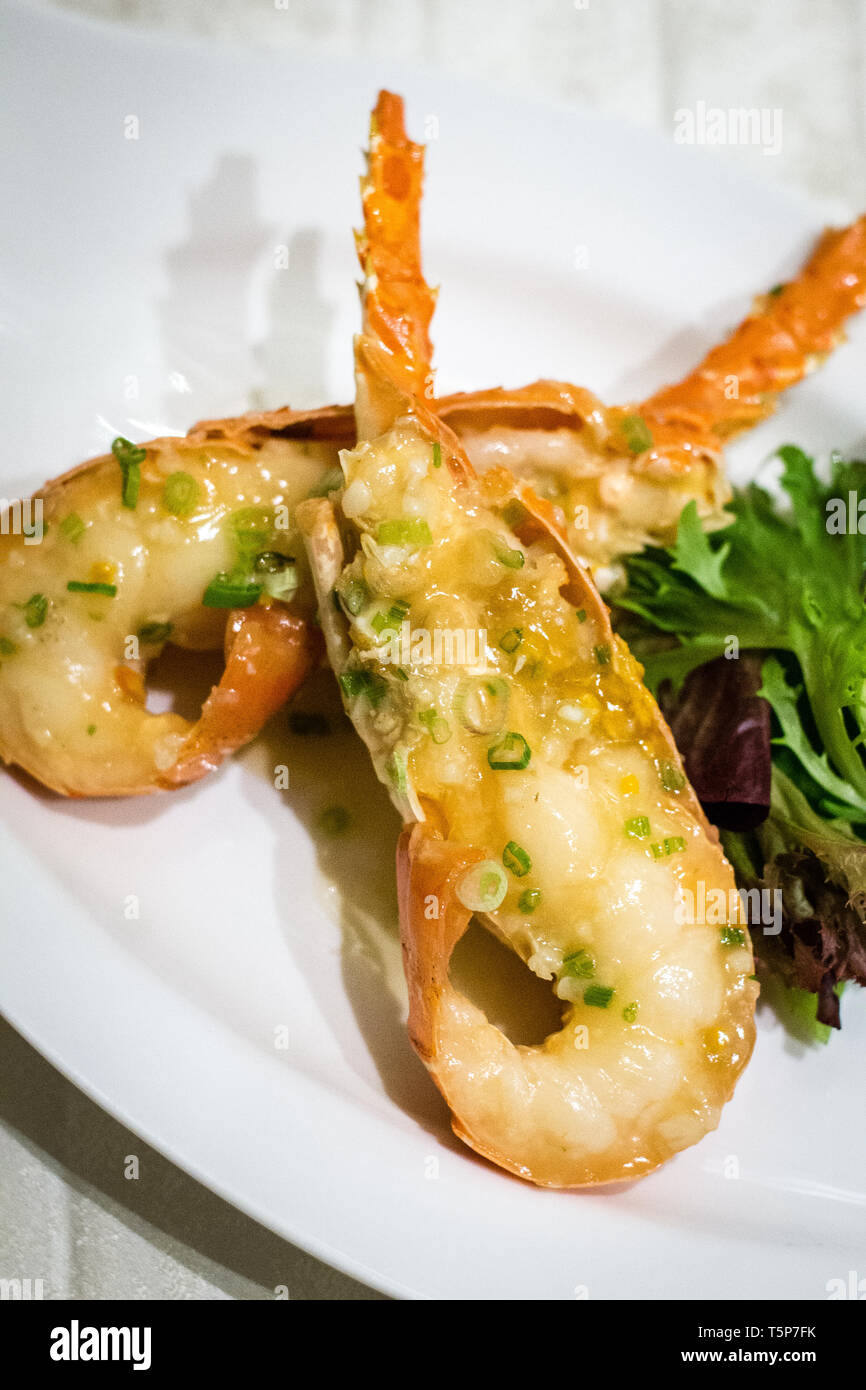 Stir fry Australian lobster with savoury sauce and spring onions and