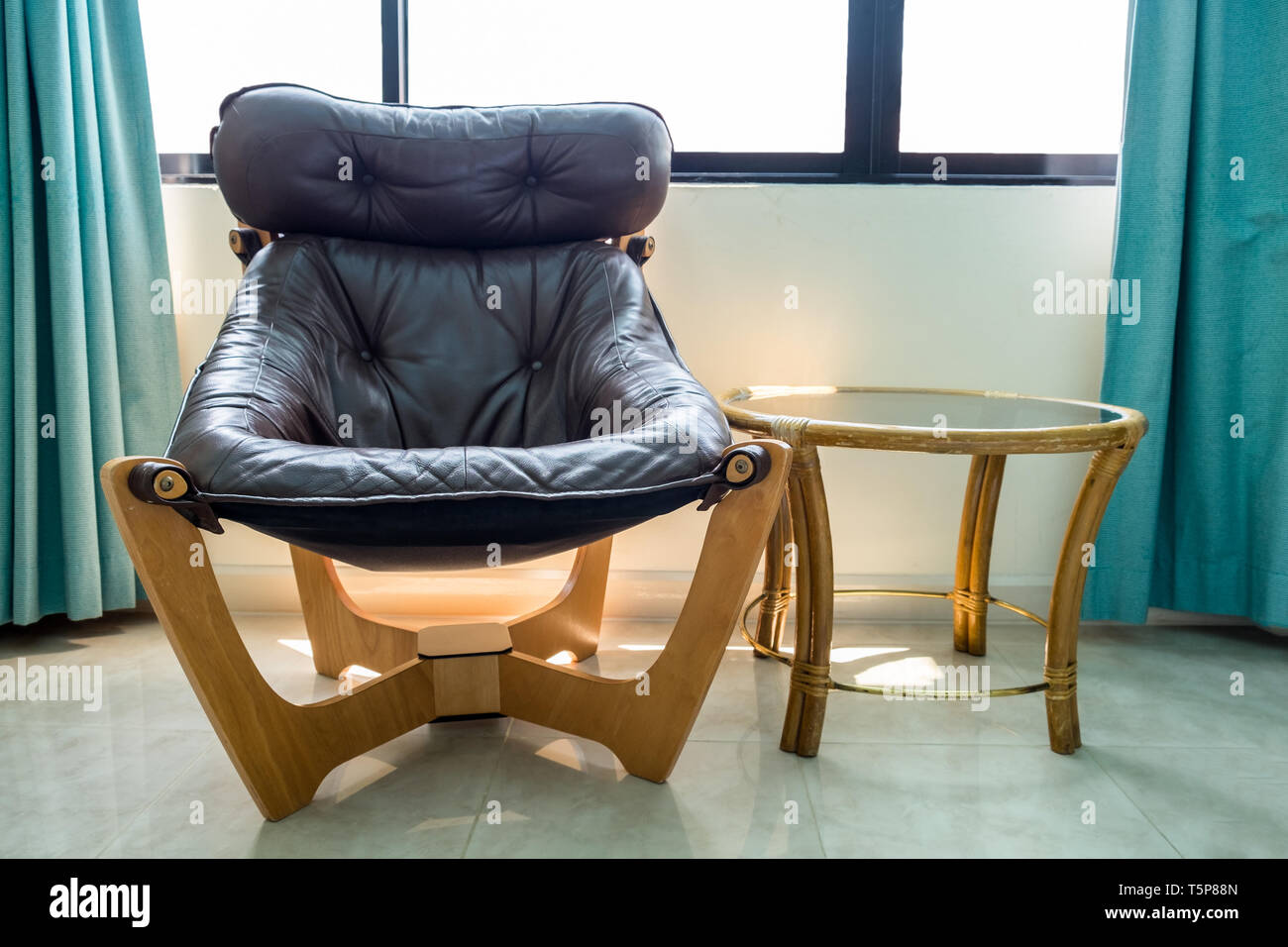 Black leather armchair with table wooden in room Stock Photo Alamy