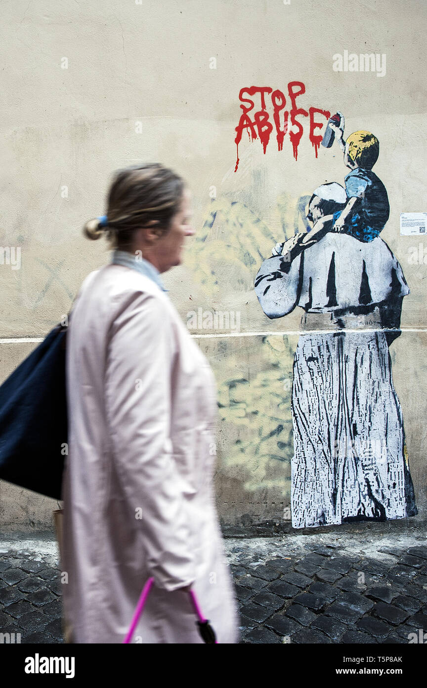 Graffiti by street artist TVBOY depicting Pope Francis from behind, with a  child on his shoulders writing on the wall 'Stop Abuse', on Vicolo degli  Osti in Rome, Italy. Featuring: atmosphere Where: