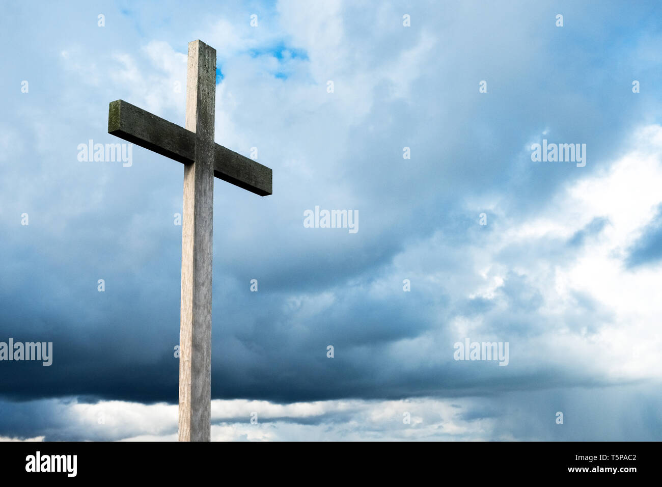 Christian cross against a dark, brooding sky Stock Photo