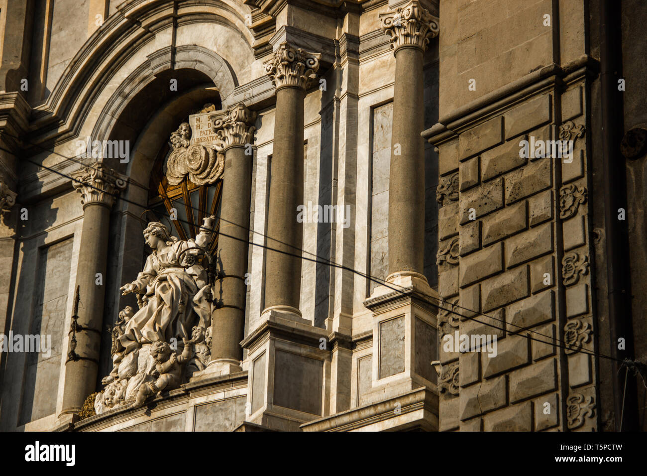 Catania cathedral facade detail with statue and baroque architecture Stock Photo
