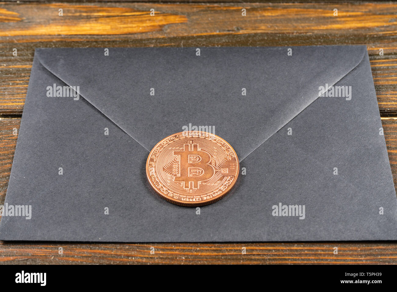 Black closed envelope on light blue background. Stock Photo