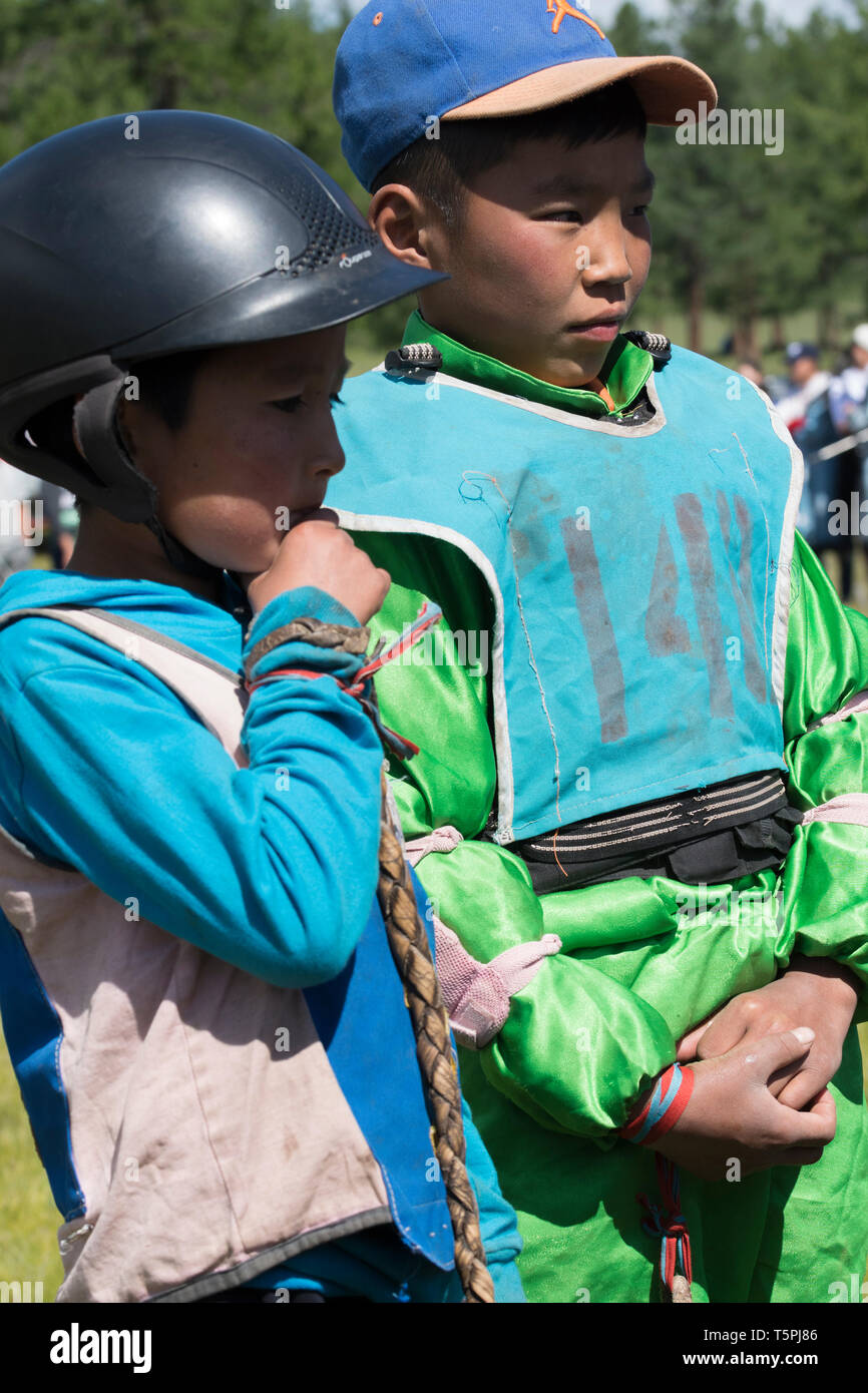 Naadam Festival in Khatgal, Mongolia.. Two young horse riders after the race Stock Photo