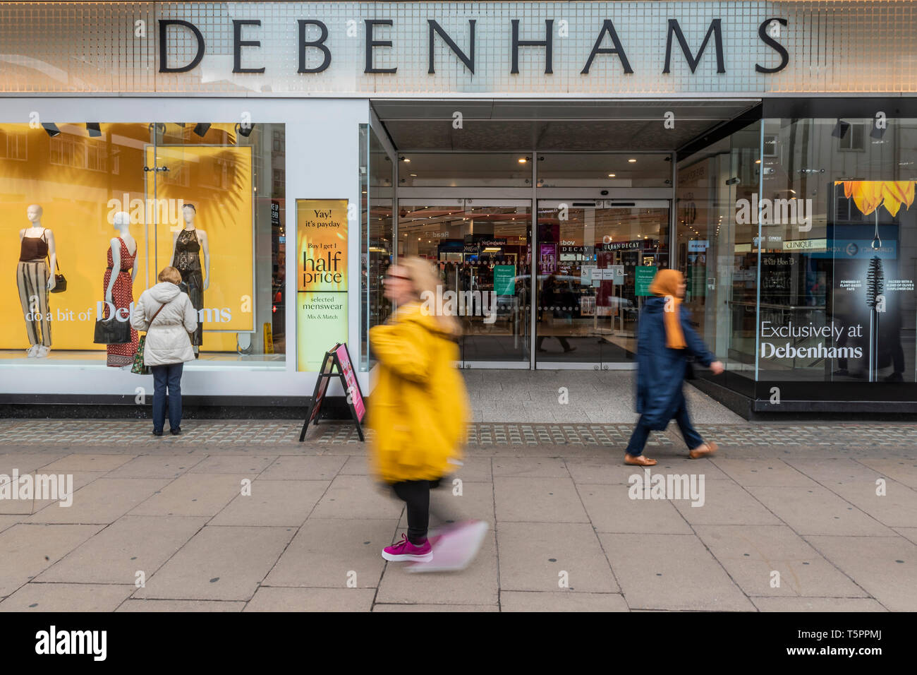 London, UK. 26th Apr 2019. Consumers pass by Debenhams Oxford Street. Debenhams names 22 store it will close by 2020. It seems its flagship store on Oxford Street is not one of them. Credit: Guy Bell/Alamy Live News Stock Photo