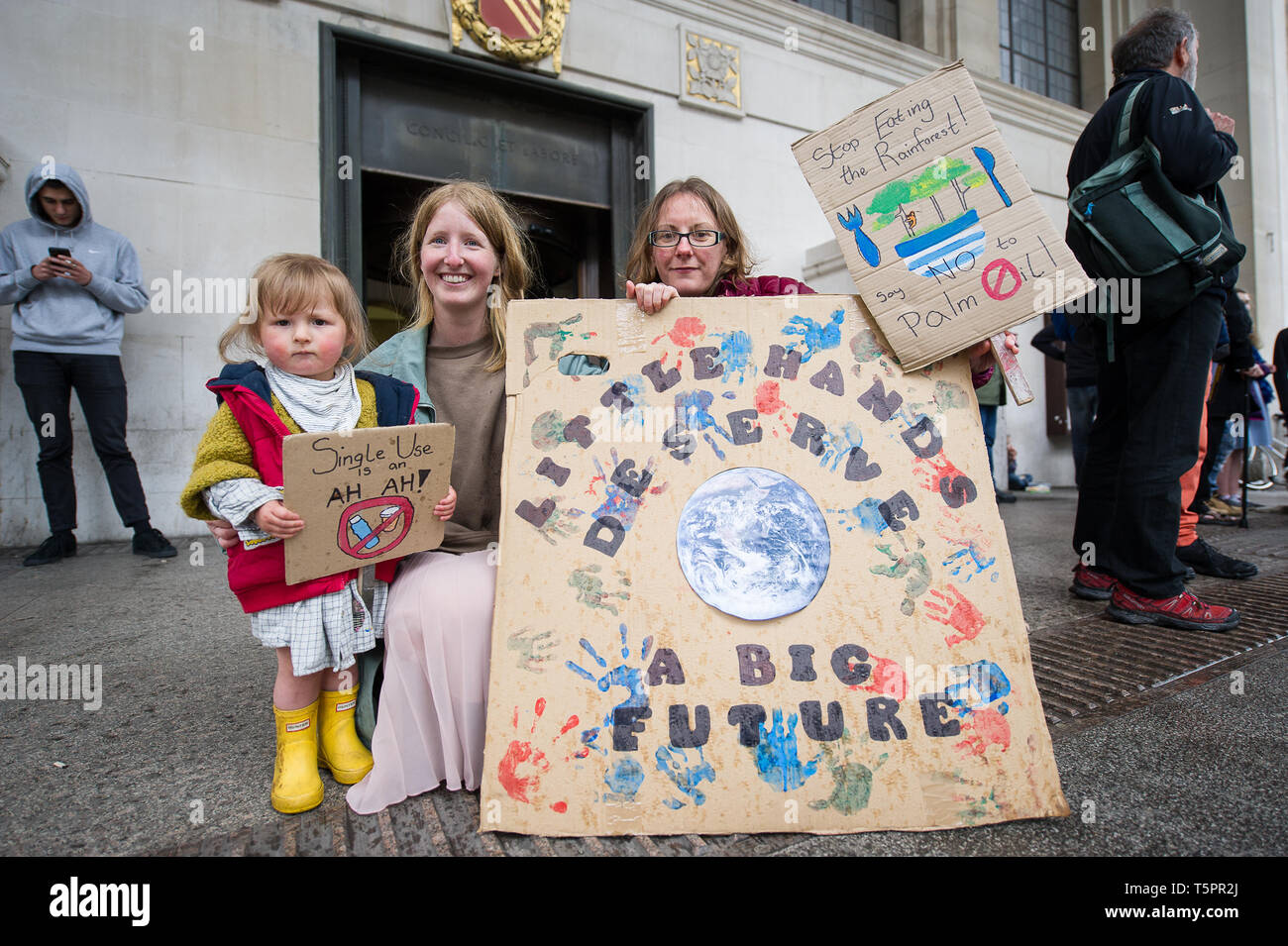 Manchester, UK. 26th Apr, 2019. A mother and daughter and friend seen with placards during the weekly Extinction Rebellion protest outside Manchester Central Library. Extinction Rebellion is a socio-political movement which uses nonviolent resistance to protest against climate breakdown, biodiversity loss, and the risk of human extinction and ecological collapse. Credit: Steven Speed/SOPA Images/ZUMA Wire/Alamy Live News Stock Photo