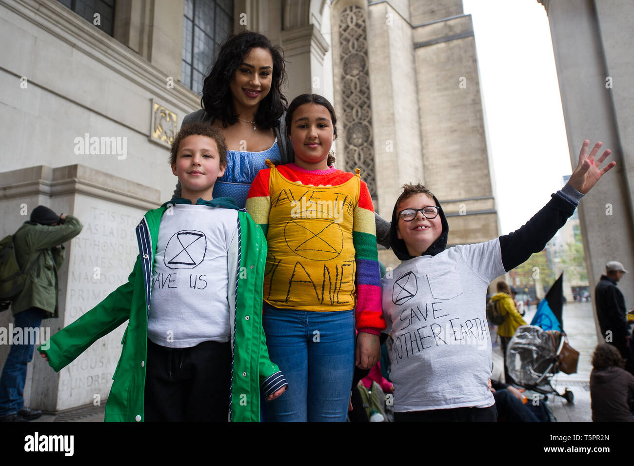 Manchester, UK. 26th Apr, 2019. Young activists seen wearing handmade protest t-shirts during the weekly Extinction Rebellion protest outside Manchester Central Library.Extinction Rebellion is a socio-political movement which uses nonviolent resistance to protest against climate breakdown, biodiversity loss, and the risk of human extinction and ecological collapse. Credit: Steven Speed/SOPA Images/ZUMA Wire/Alamy Live News Stock Photo