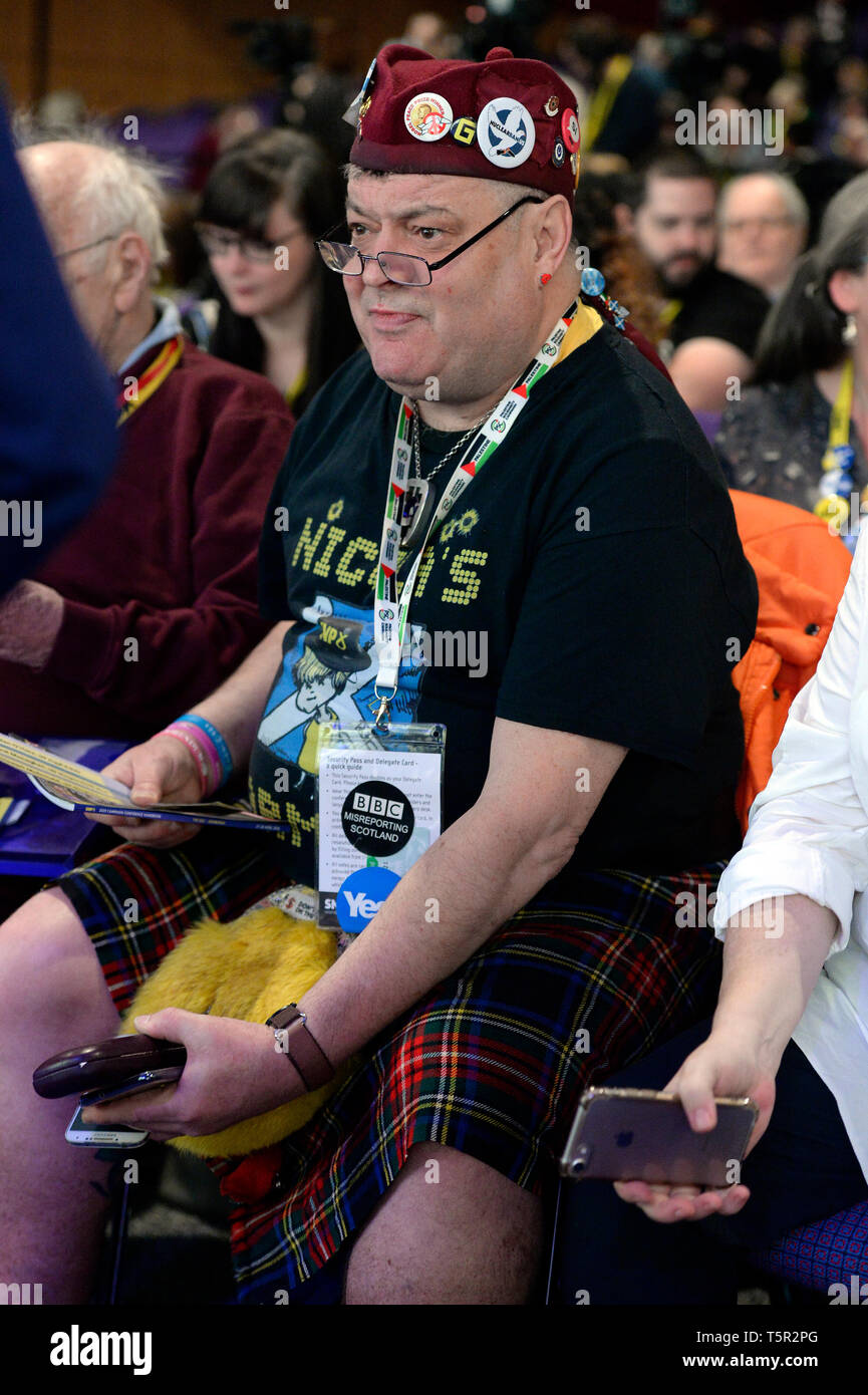 Edinburgh, Scotland, United Kingdom. 27th Apr, 2019. A delegate in colourful costume listens to the opening address at the Scottish National Party's Spring Conference in the Edinburgh International Conference Centre. Credit: Ken Jack/Alamy Live News Stock Photo
