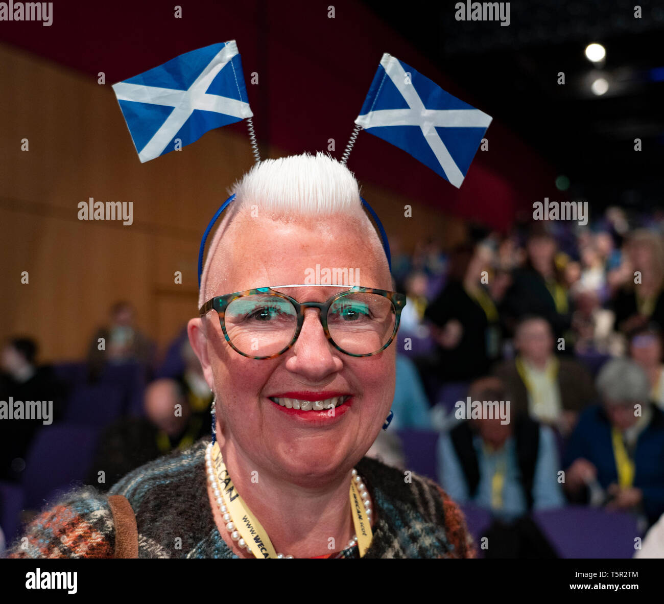 Edinburgh, Scotland, UK. 27th Apr, 2019. SNP ( Scottish National Party) Spring Conference takes place at the EICC ( Edinburgh International Conference Centre) in Edinburgh. Pictured Agnes Magowan a delegate at the conference with patriotic headwear. Credit: Iain Masterton/Alamy Live News Credit: Iain Masterton/Alamy Live News Stock Photo