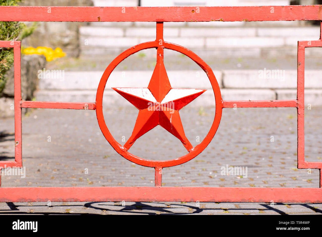 Red metal star in circle. Red army star symbol forged in metal gate to Russian military cemetery. Katowice Poland Stock Photo