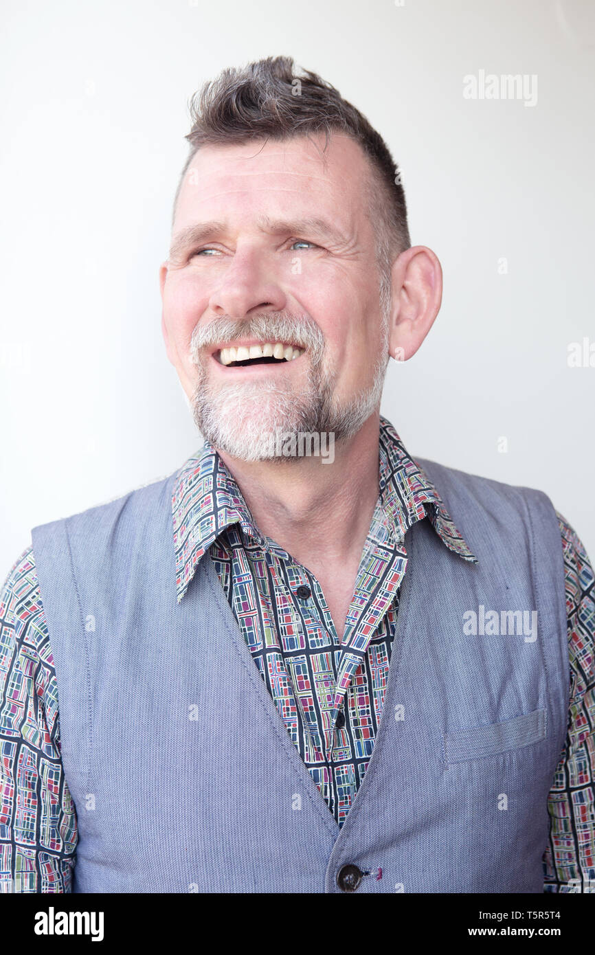 Portrait Of Smiling Handsome Grey Haired Man In His 50s Stock