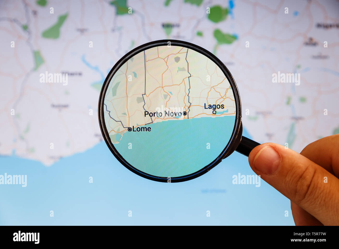 Porto Novo, Benin. Political map. City visualization illustrative concept on display screen through magnifying glass in the hand. Stock Photo