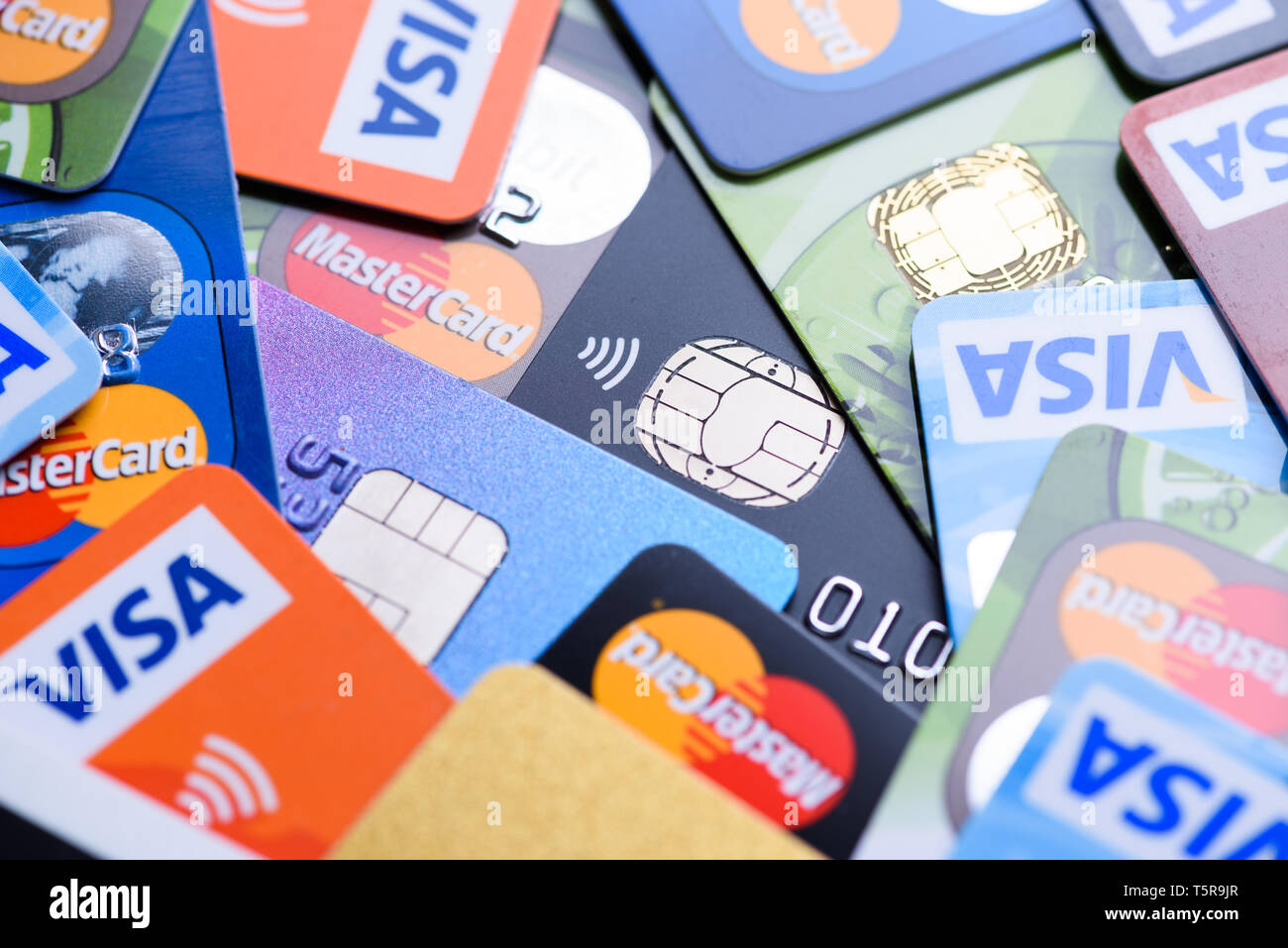 Krakow, Poland - June 16, 2017: Plastic bank payment cards close-up, Visa and Mastercard, credit and debit with different chips and wireless payment t Stock Photo