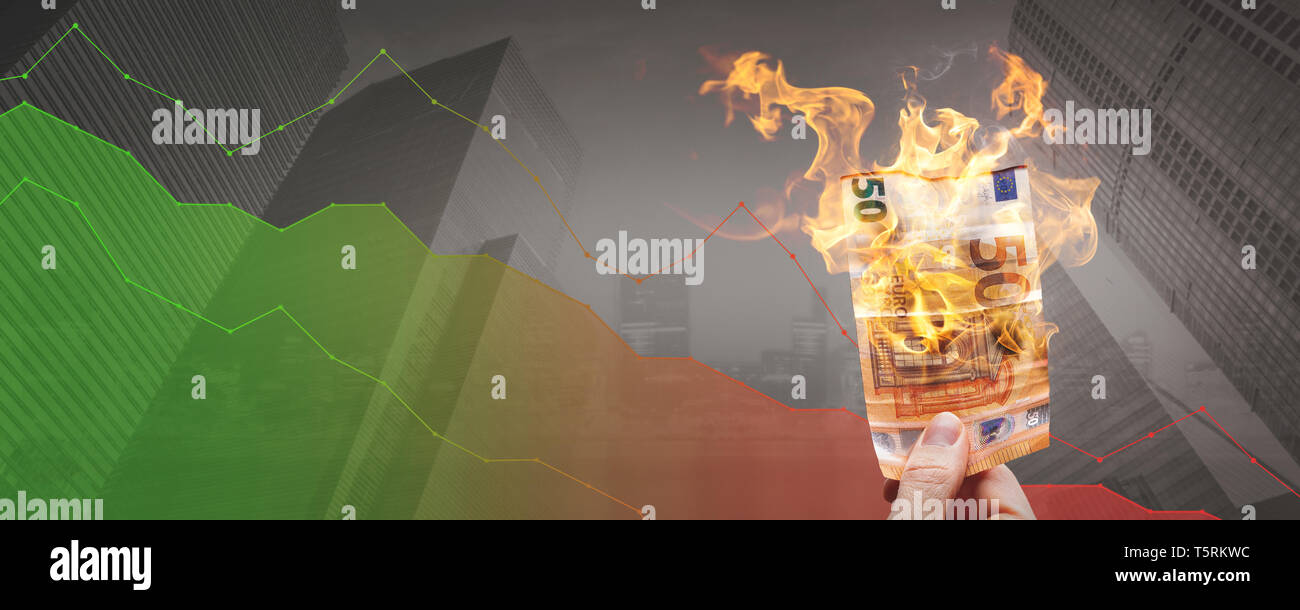 Loosing money concept - burning 50€ bill in front of a declining graph Stock Photo