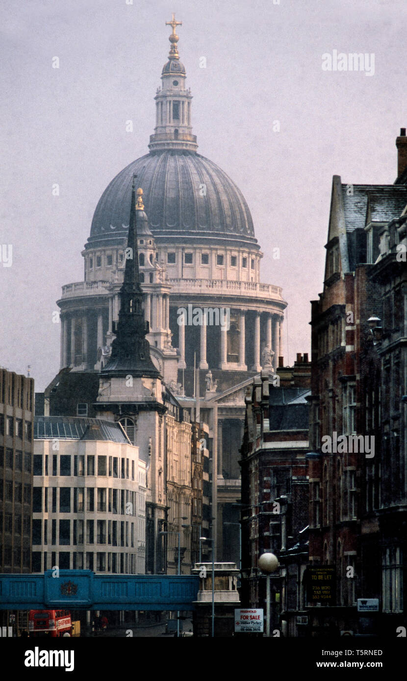 St Paul's Cathedral in the City of London, London England. 1980 St Paul's Cathedral, London, is an Anglican cathedral, the seat of the Bishop of London and the mother church of the Diocese of London. It sits on Ludgate Hill at the highest point of the City of London and is a Grade I listed building. Its dedication to Paul the Apostle dates back to the original church on this site, founded in AD 604. The present cathedral, dating from the late 17th century, was designed in the English Baroque style by Sir Christopher Wren. Its construction, completed in Wren's lifetime, was part of a major rebu Stock Photo