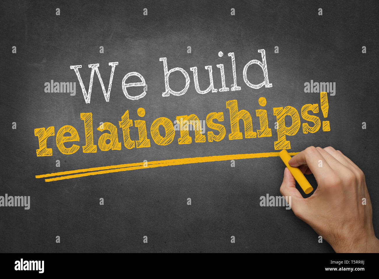 hand writes on chalkboard - We build relationships! Stock Photo