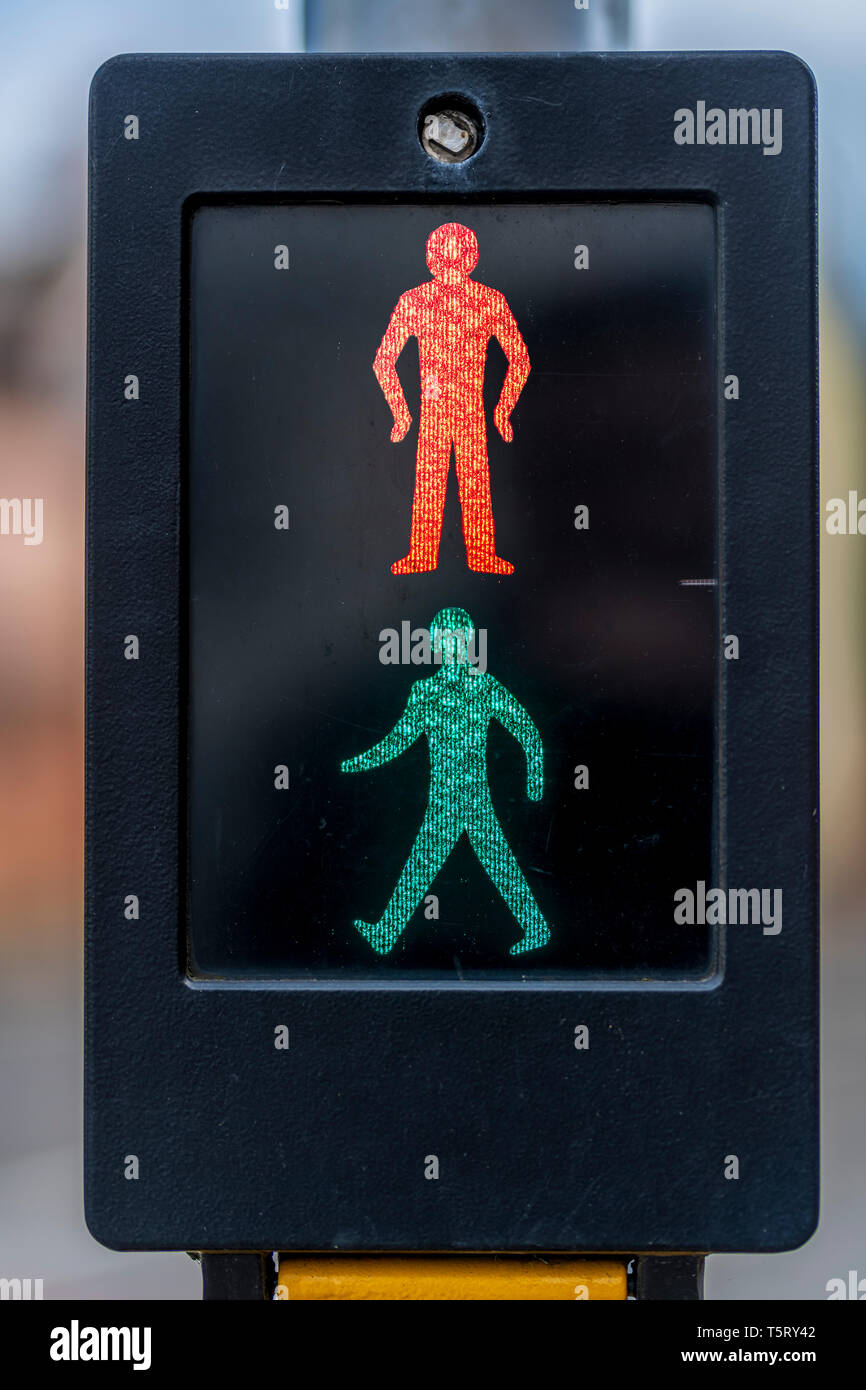 The classic design of the pedestrian crossing showing both the red and green man illuminated. Stock Photo