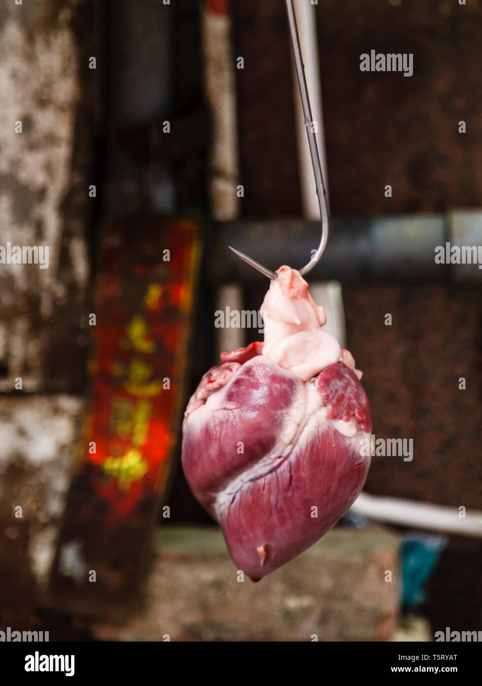 pigs heart hanging up on a butchers hook on a stall in Bowrington Road, Wan Chai, Hong Kongong Stock Photo