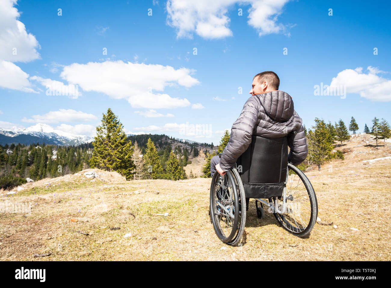 Young disabled man in wheelchair outside nature mountains and nature Stock Photo - Alamy