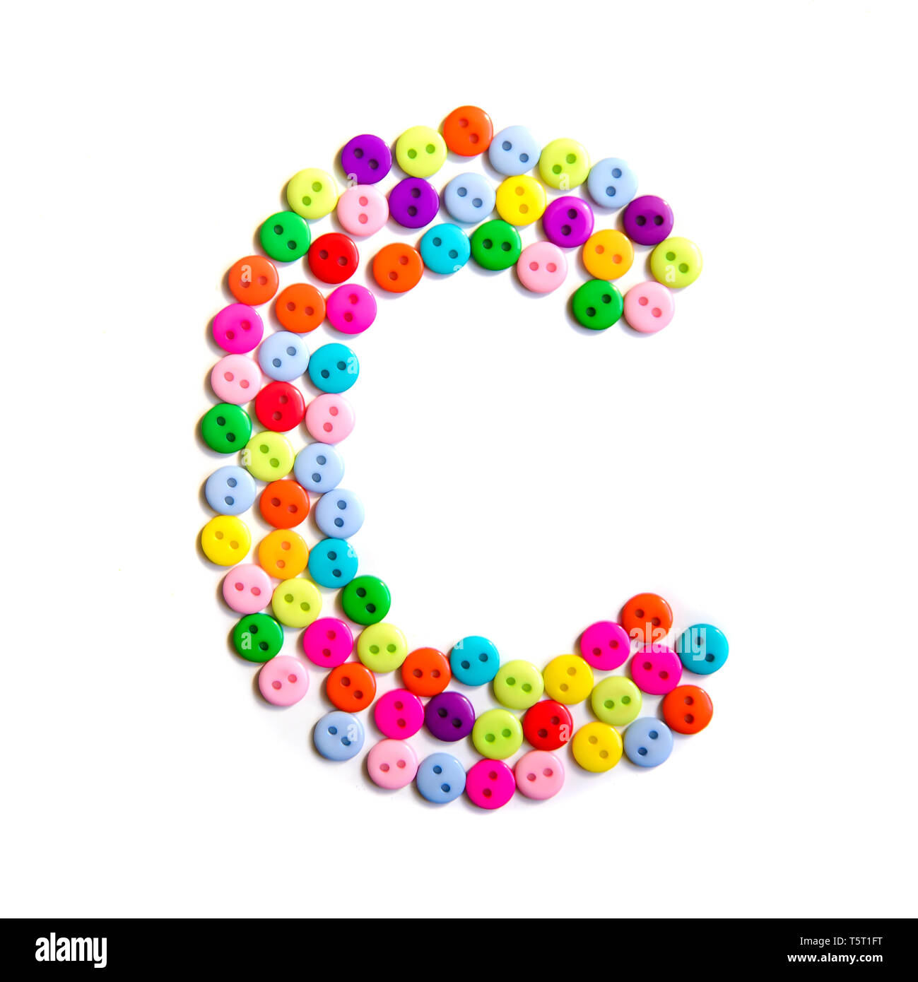 Letter C of the English alphabet from a group of colorful small buttons on a white background Stock Photo
