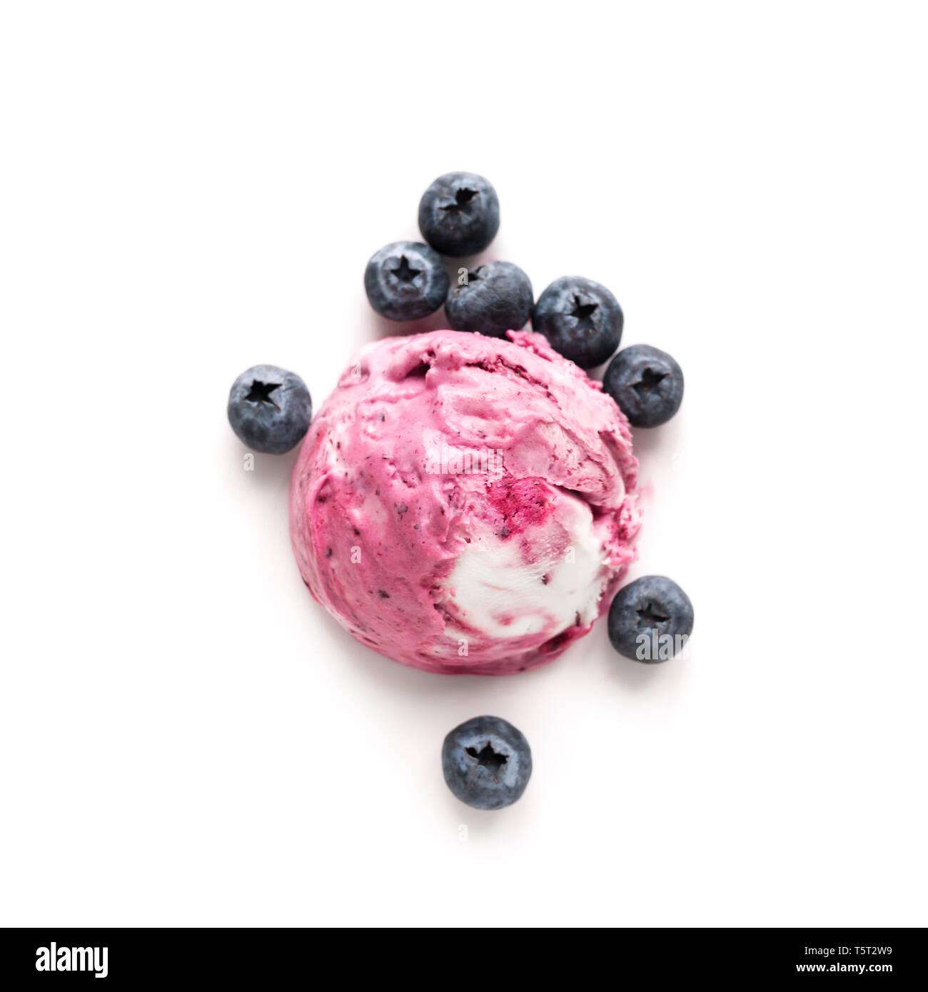Blueberry Ice Cream isolated on white background, top view, copy space. Scoop of pink berry blueberry icecream with fresh blueberries. Stock Photo