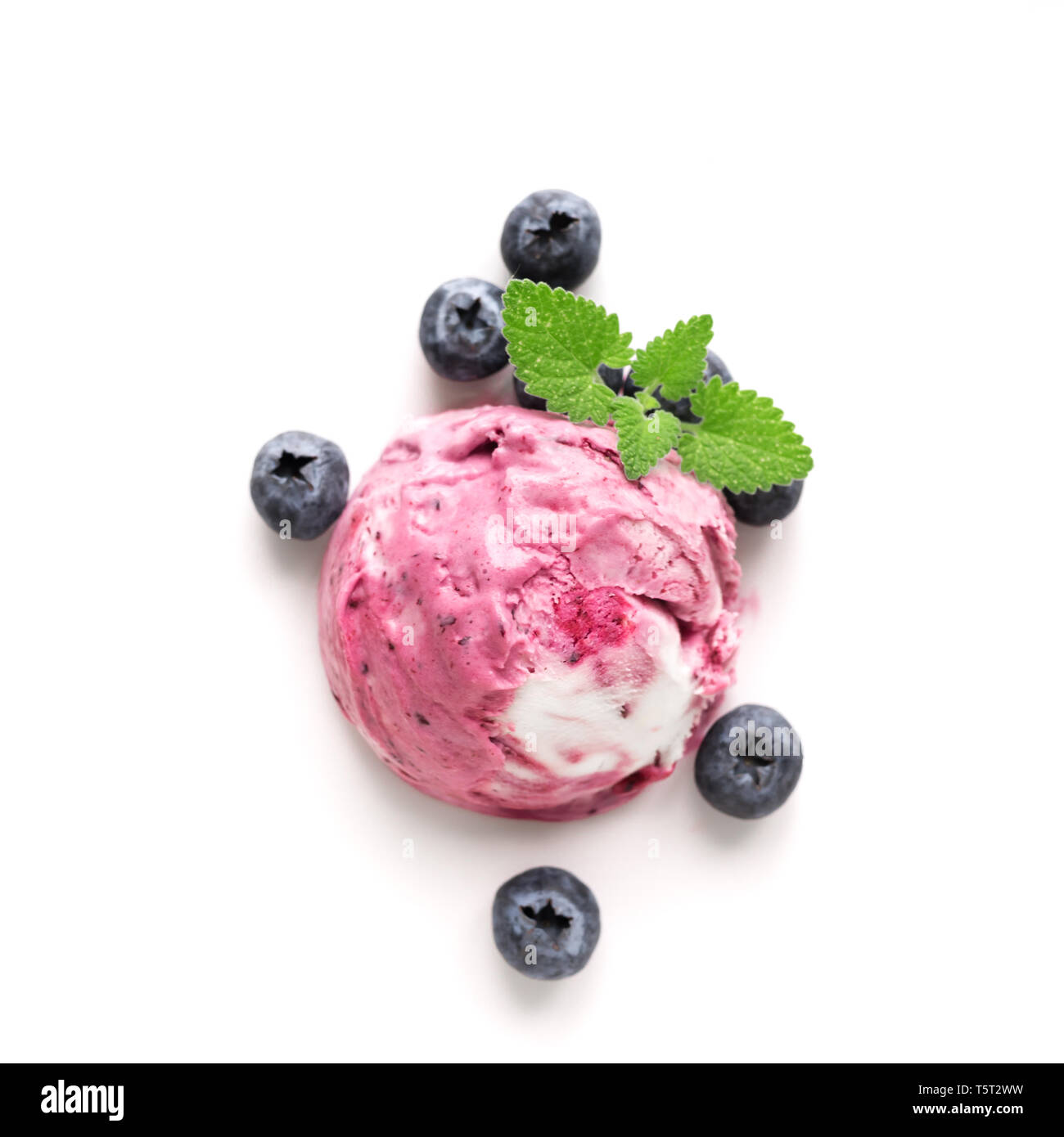 Blueberry Ice Cream isolated on white background, top view, copy space. Scoop of pink berry blueberry icecream with blueberries and mint. Stock Photo