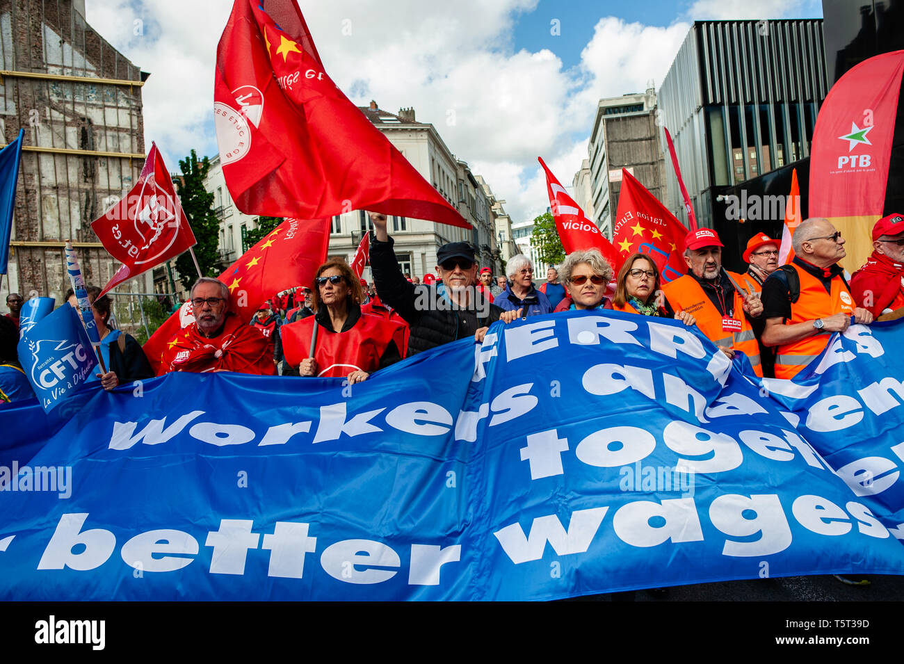 A Group Of Workers Seen Holding A Huge Banner And Flags During The