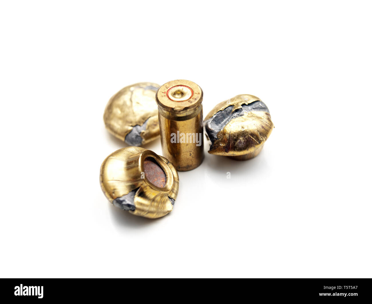 Fired bullets and a shell on a white backgorund. Stock Photo