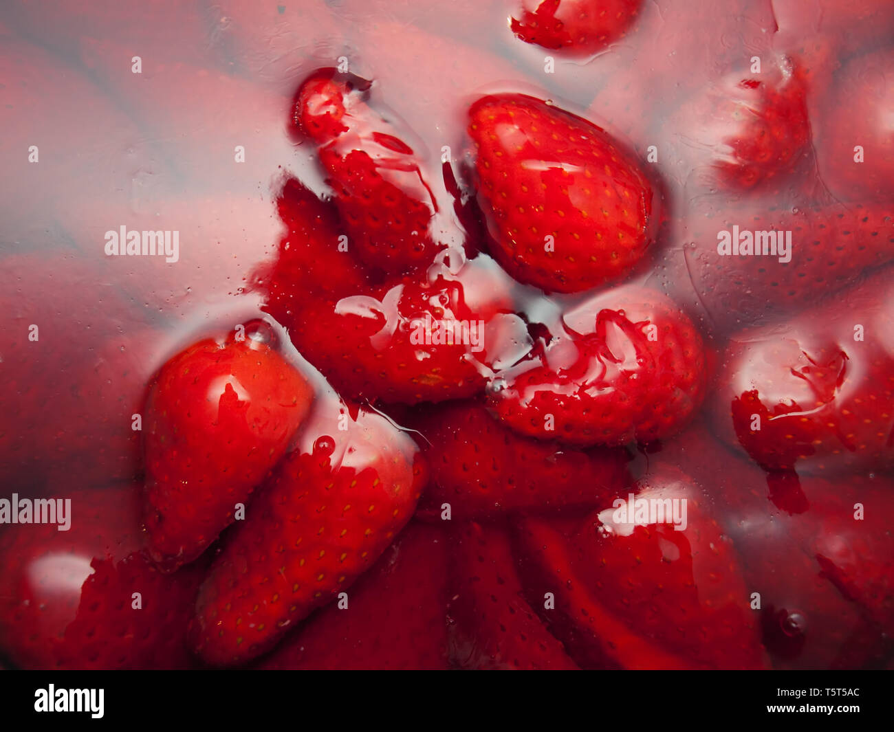Ripe strawberries covered with jelly. Stock Photo