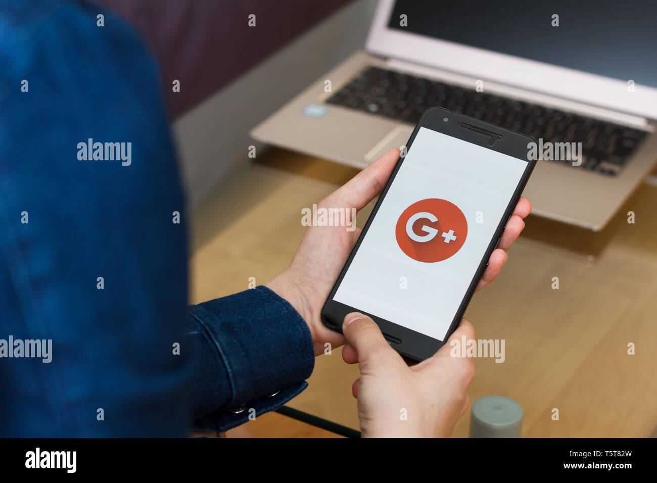SAN FRANCISCO, US - 22 April 2019: Close up to female hands holding smartphone using Google plus for G Suite application, San Francisco, California, U Stock Photo