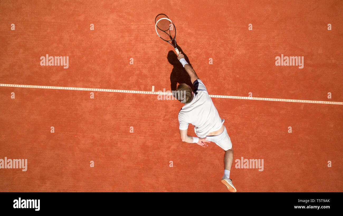 Top view of tennis player in action on tennis court Stock Photo