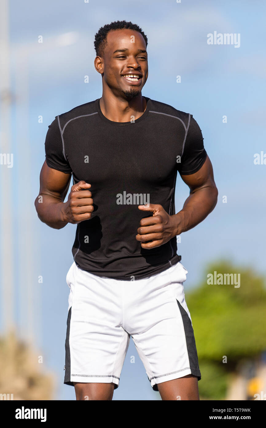 Attractive young african man stretching hi-res stock photography and ...